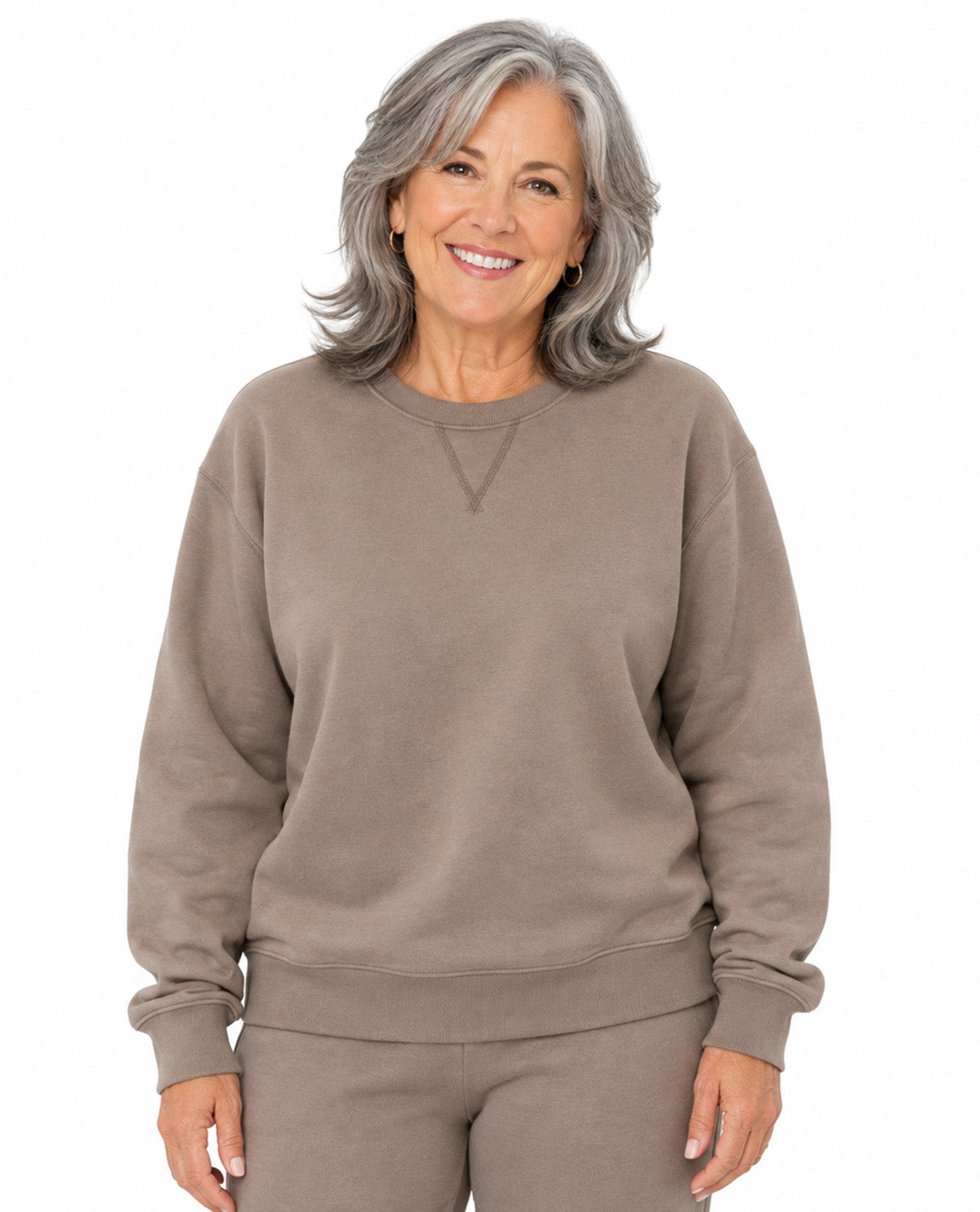 Model wearing a brown top with a white background