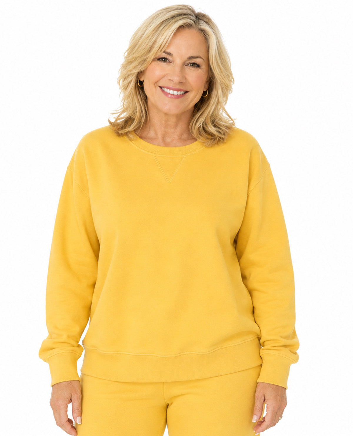 Model wearing a yellow top with a white background