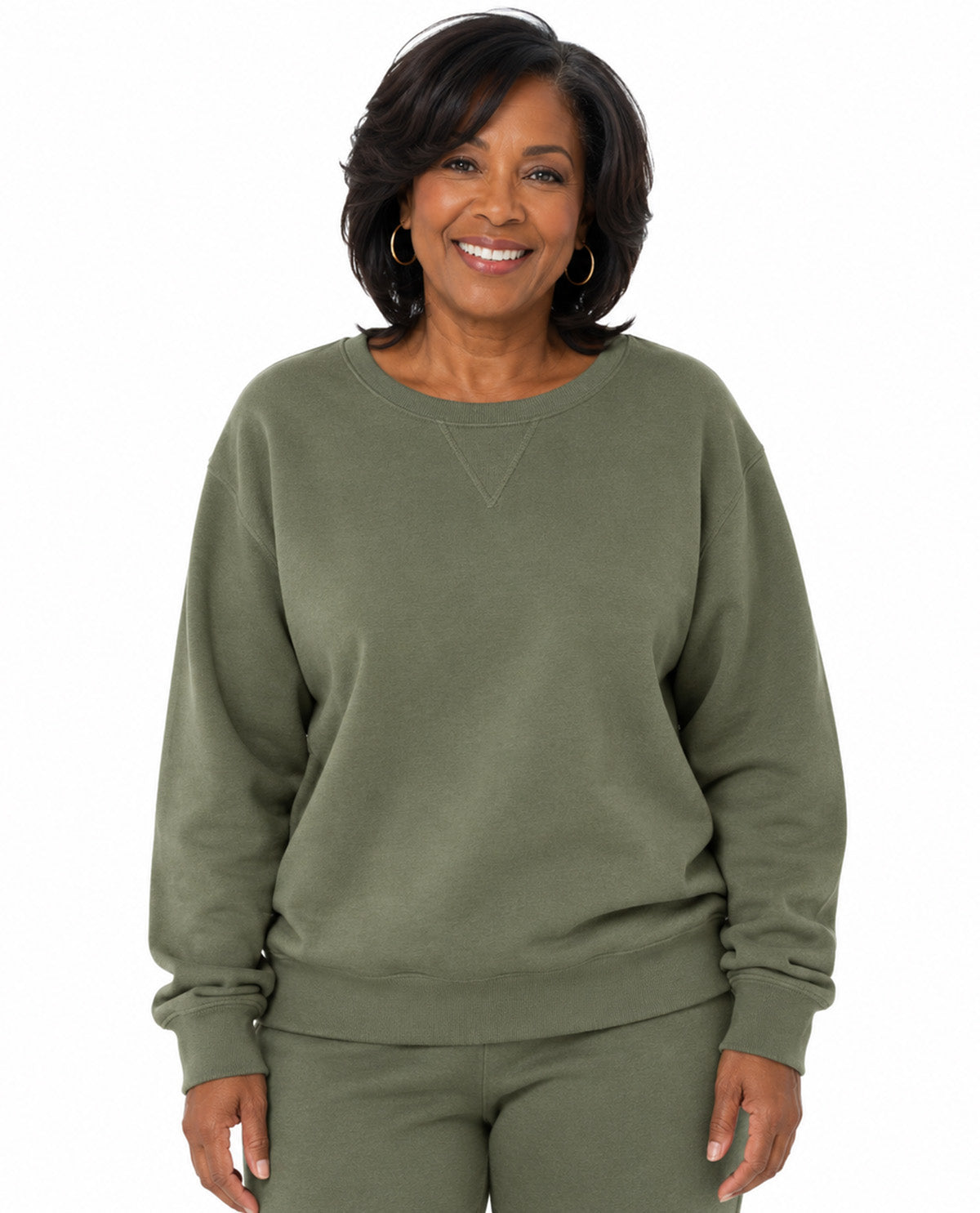 Model wearing a green top with a white background