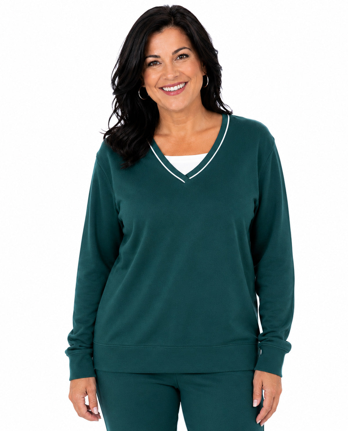 A woman modeling a dark green long-sleeve V-neck sweatshirt with thin white piping trim along the neckline, paired with matching green pants, against a plain white background.