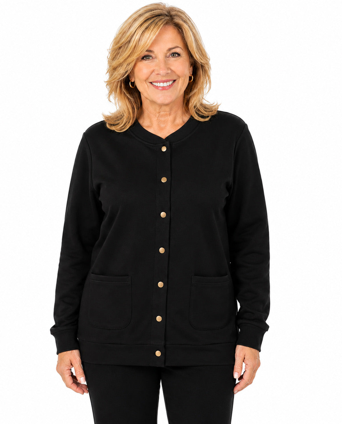 A smiling woman with blonde hair wearing a black long-sleeve button-front cardigan with gold-tone buttons and two front patch pockets, paired with black pants, against a plain white background.