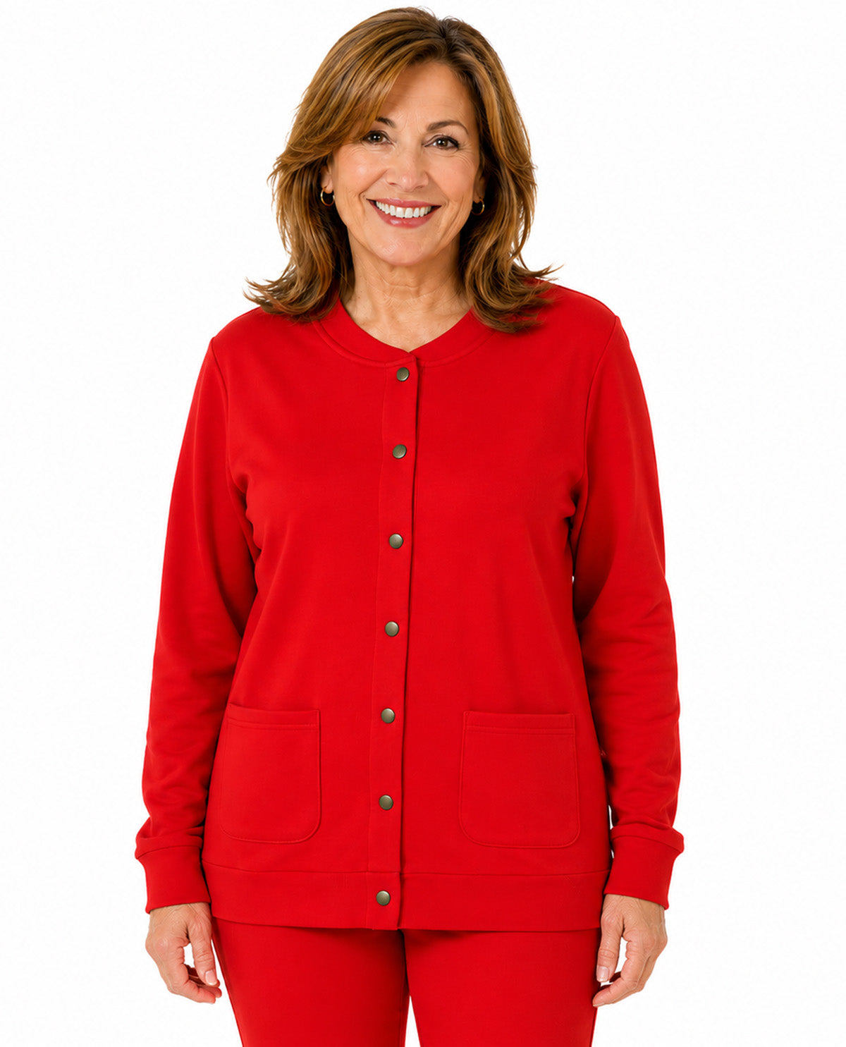 A smiling woman with shoulder-length brown hair wearing a bright red long-sleeve button-front cardigan with two front patch pockets and matching red pants, photographed against a plain white studio background.