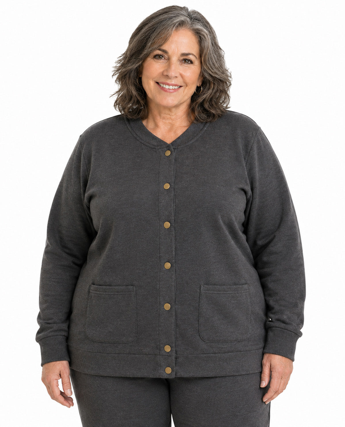 A smiling woman with shoulder-length gray hair wearing a dark charcoal gray button-up cardigan with front pockets, shown against a plain white background.