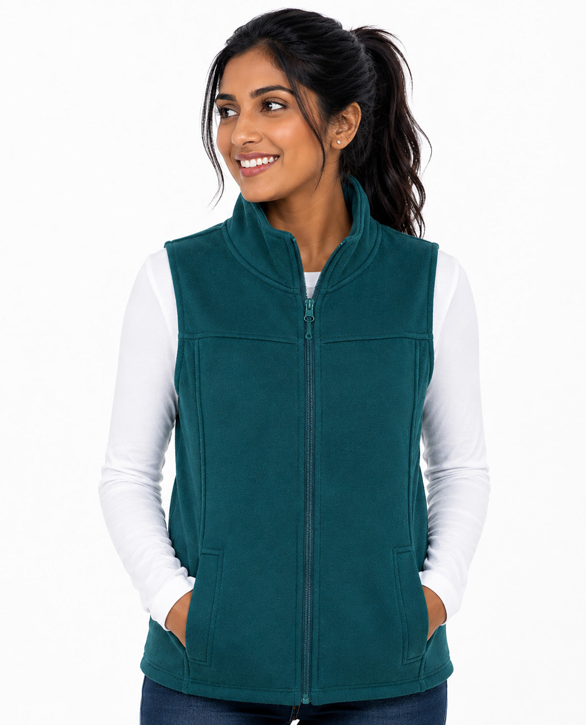 A woman wearing a teal green zip-up fleece vest over a white long-sleeve shirt, shown against a plain white background.