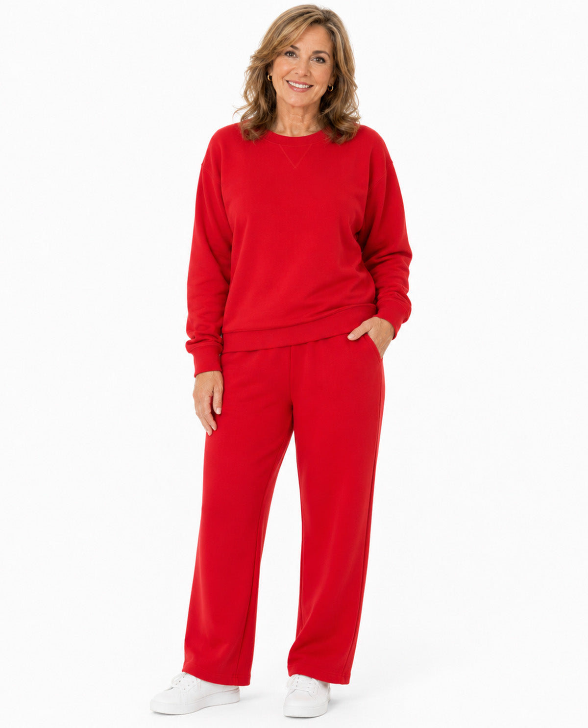 A woman modeling a matching red sweatshirt and wide-leg sweatpants set against a plain white studio background.