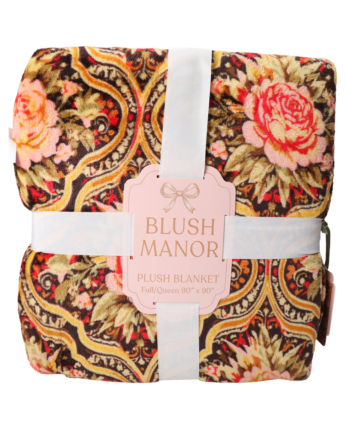 A folded plush blanket with a detailed paisley and floral pattern in pink, gold, and brown, wrapped in white ribbons with a central pink tag reading 'BLUSH MANOR'.