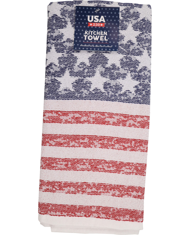A folded kitchen towel featuring a distressed American flag pattern with navy blue stars on a white background and red and white stripes. A dark blue label at the top reads 'USA KITCHEN TOWEL'.