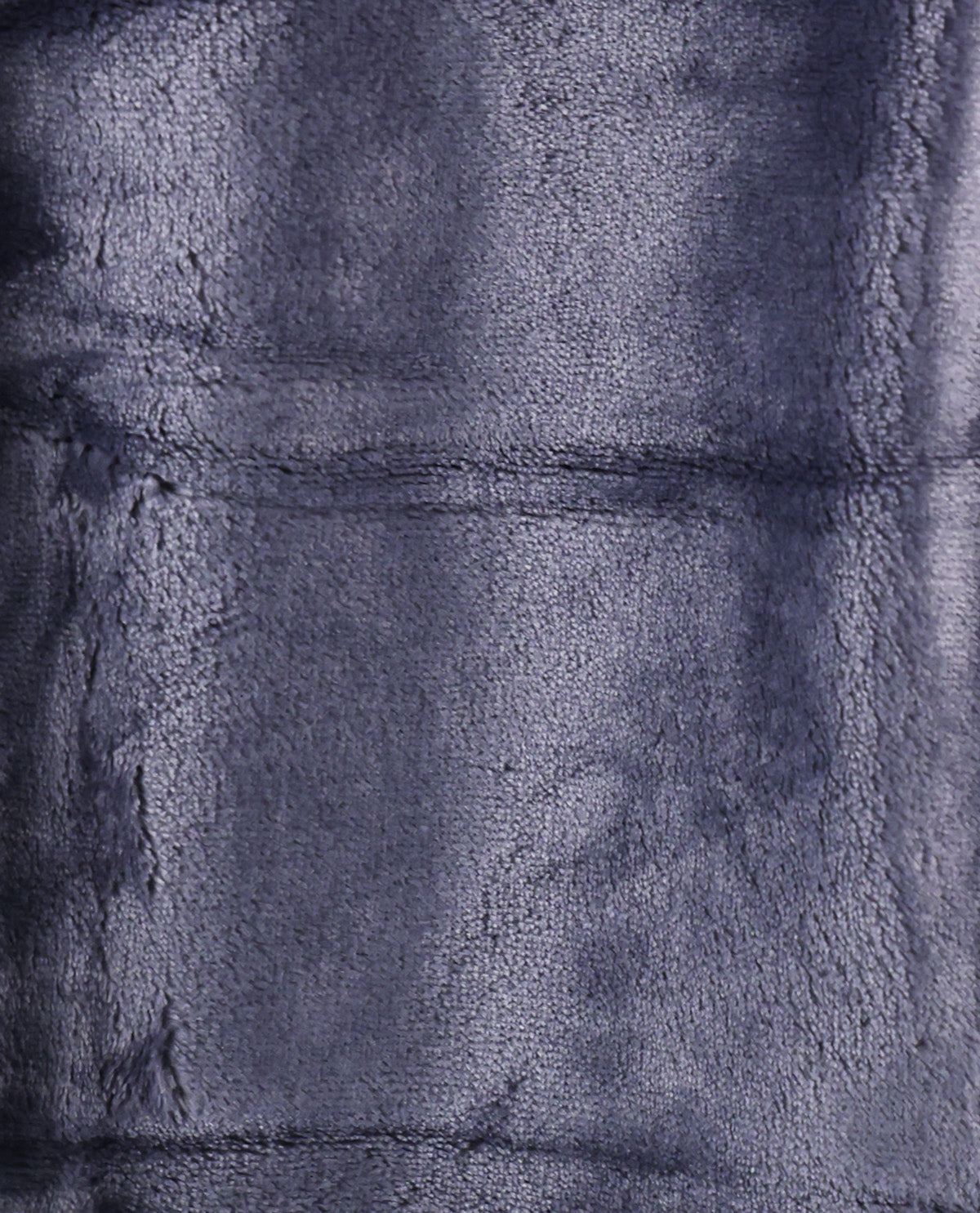 A close-up of a plush, textured fabric in a dark slate blue or navy color, showing the soft pile and stitched panel seams.