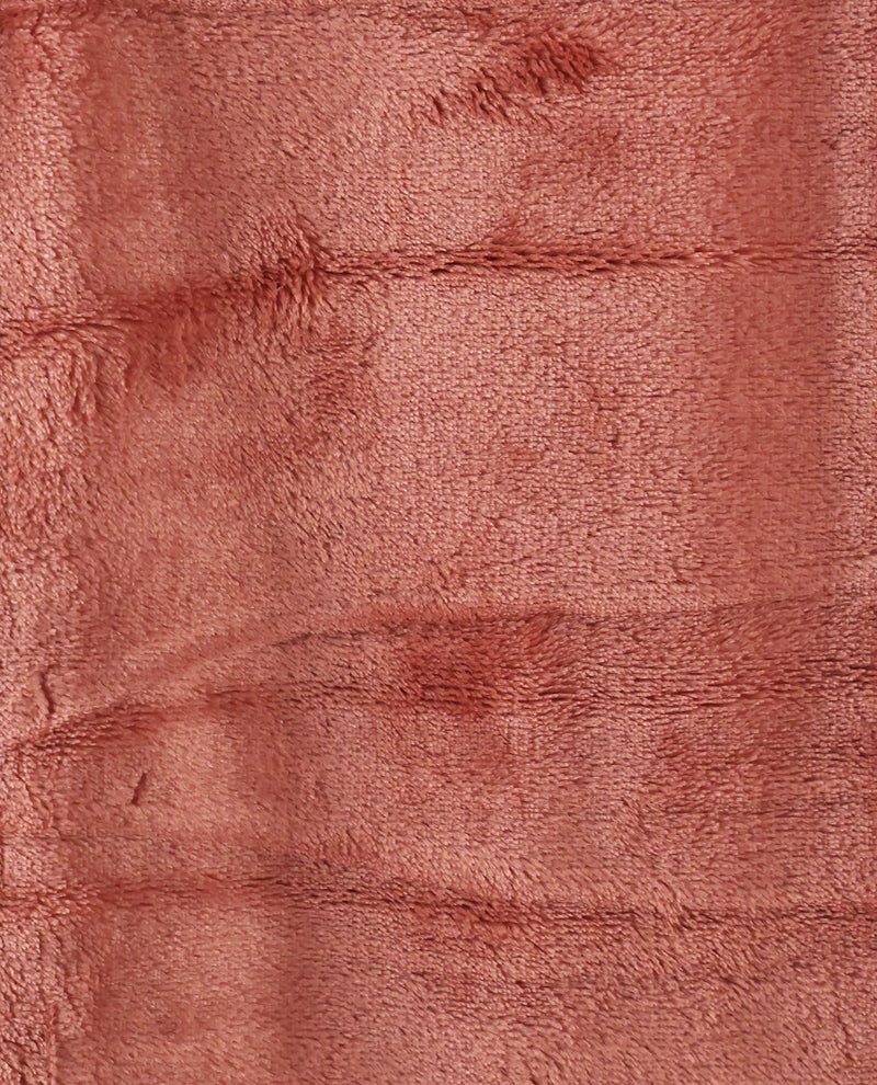 A close-up of a dusty rose pink plush fabric texture with soft horizontal folds.