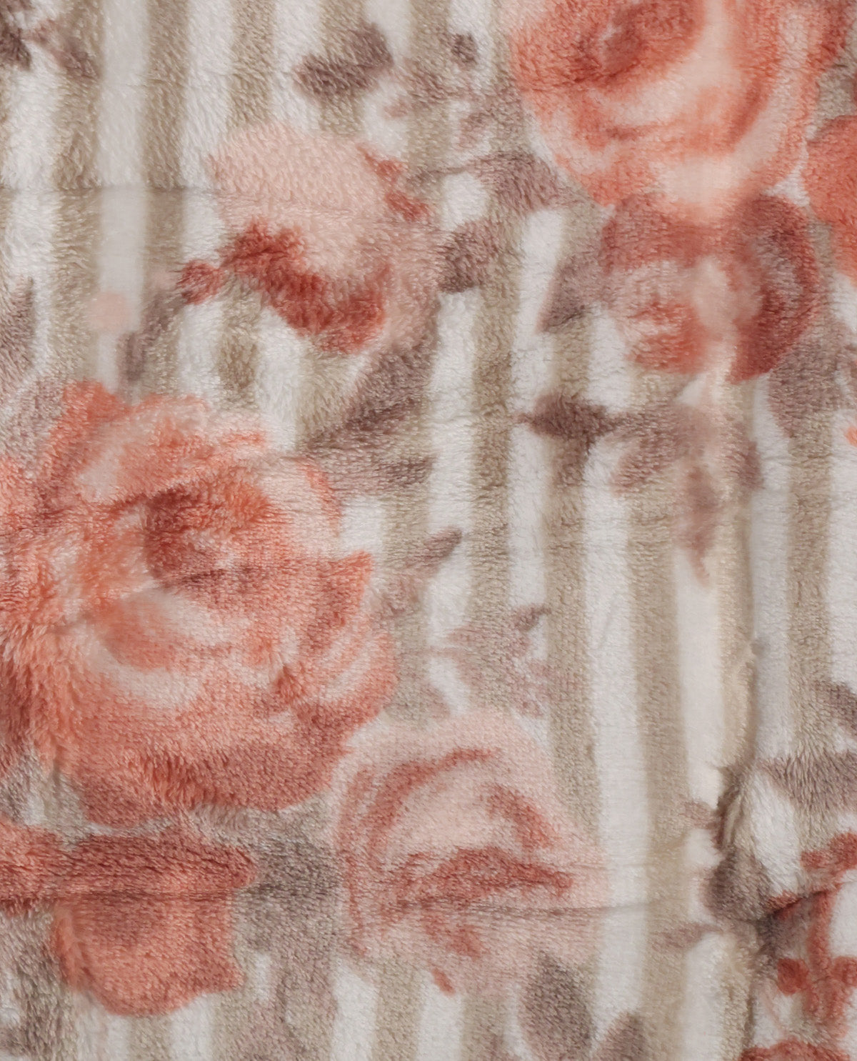 Close-up of a plush fabric with a floral print featuring dusty pink roses and muted brown leaves over a light beige and gray striped background.