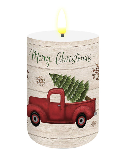Decorative candle with a red truck and Christmas tree on a wooden-textured background, featuring 'Merry Christmas' text.