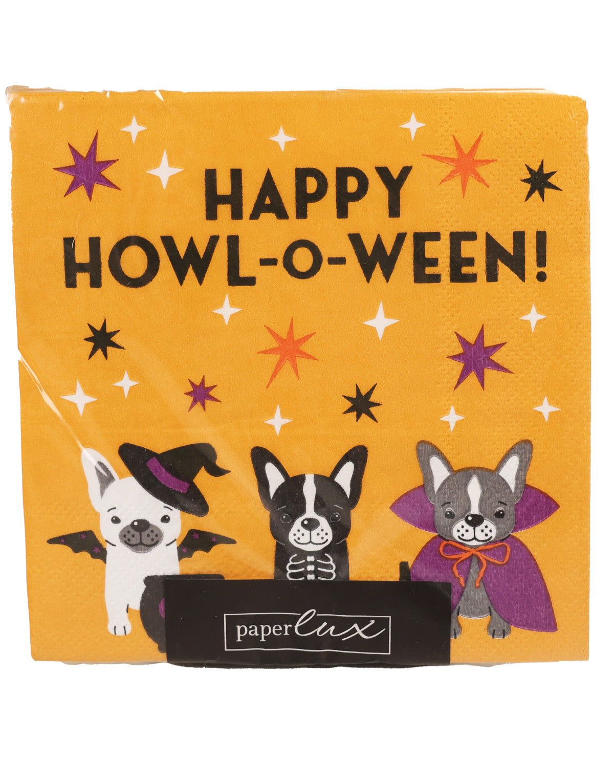 A square yellow paper napkin with a Halloween theme, featuring the text 'HAPPY HOWLO-WEEEN!' and three cartoon dogs dressed as a witch, vampire, and skeleton. The napkin is branded with 'paperlux' on a black ribbon at the bottom.