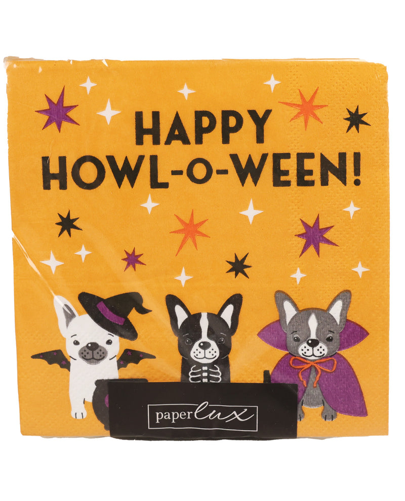 A square yellow paper napkin with a Halloween theme, featuring the text 'HAPPY HOWLO-WEEEN!' and three cartoon dogs dressed as a witch, vampire, and skeleton. The napkin is branded with 'paperlux' on a black ribbon at the bottom.