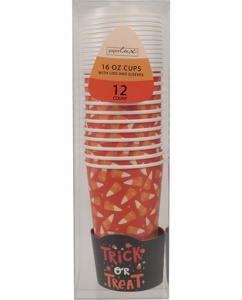 A 12-pack of Paperlux 16 oz cups with lids and sleeves, featuring a Halloween candy corn pattern in orange, white, and yellow, packaged in a clear plastic box with a black 'Trick or Treat' base band.