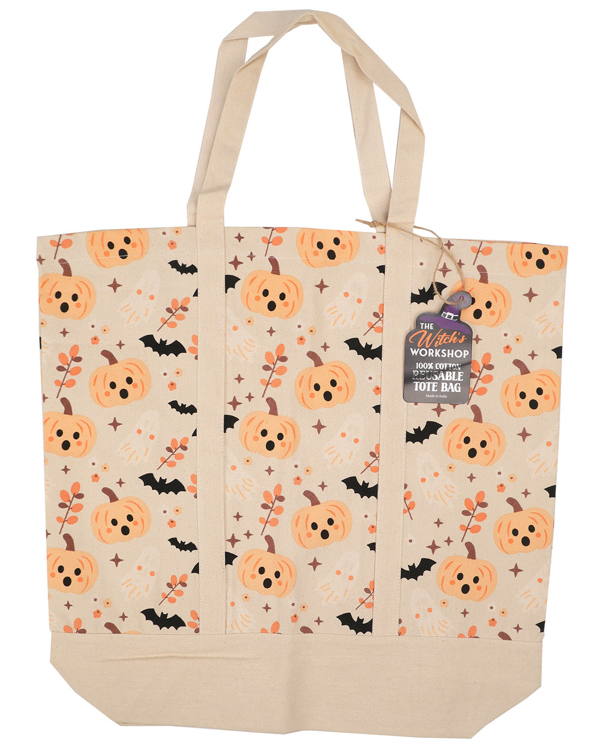 A canvas tote bag with a Halloween pattern featuring orange pumpkins, black bats, and orange leaves on a cream background, with a hanging tag that reads 'The Witch's Workshop'.