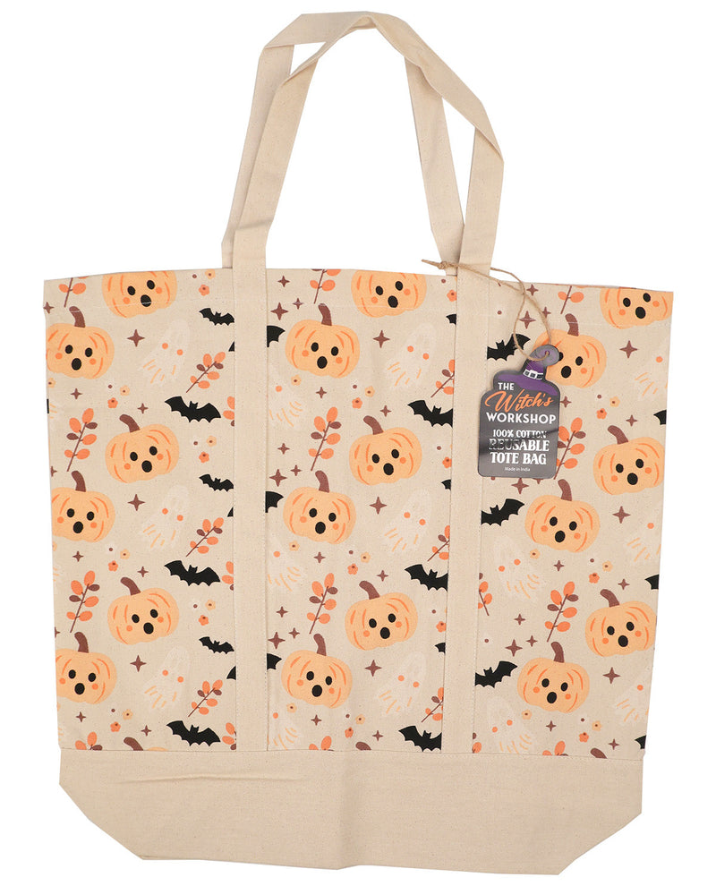 A canvas tote bag with a Halloween pattern featuring orange pumpkins, black bats, and orange leaves on a cream background, with a hanging tag that reads 'The Witch's Workshop'.