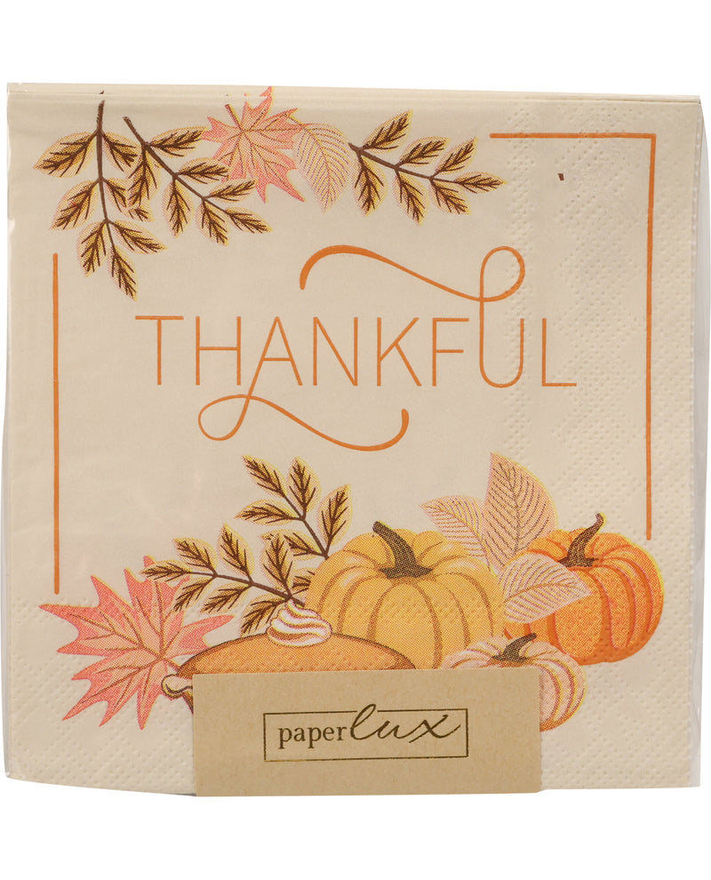 A square paper napkin with a fall harvest design, featuring the word 'THANKFUL' in orange script, surrounded by pumpkins, leaves, and branches. A small paper tag at the bottom reads 'paperlux'.