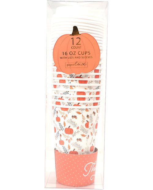 A 12-count pack of 16 oz paper cups with lids and sleeves by PaperCupz, featuring a fall harvest pattern of pumpkins, leaves, and orange stripes on a white background, packaged in a clear plastic sleeve with a decorative orange pumpkin-shaped label.