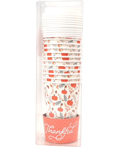 A stack of paper cups with a fall harvest pattern of pumpkins, leaves, and acorns, packaged in a clear plastic sleeve with a coral-colored sleeve at the bottom that says 'Thankful' in white script.