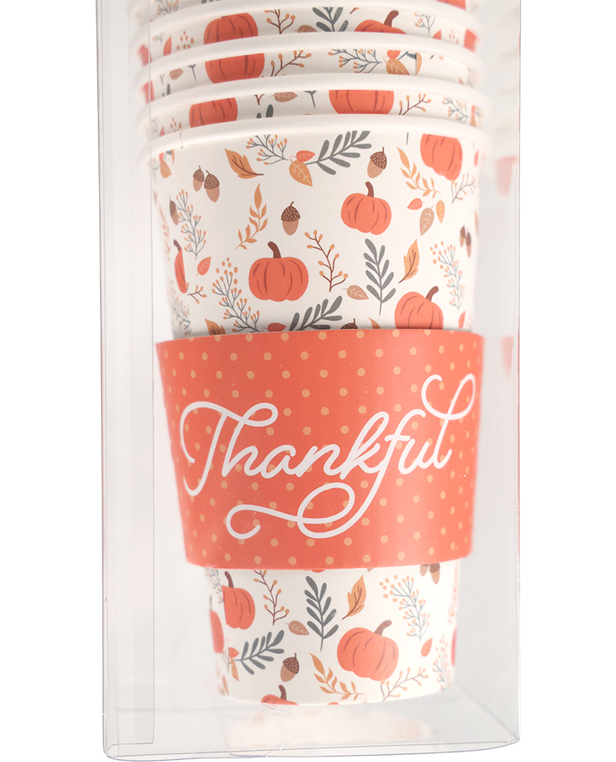 A stack of white paper cups with a fall harvest pattern of orange pumpkins, acorns, and leaves, wrapped in a coral orange sleeve with white 'Thankful' script, shown inside a clear plastic packaging box.