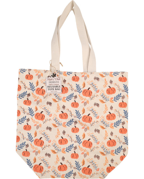 A reusable tote bag by Main's Pick The Horizon, featuring a cream-colored base with an all-over autumn pattern of orange pumpkins, blue leaves, and brown acorns. The bag has two cream canvas shoulder straps and a hanging paper tag on the left side.