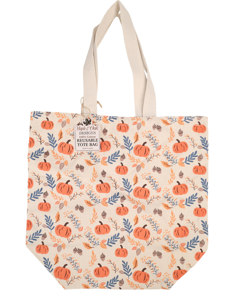 A reusable tote bag by Main's Pick The Horizon, featuring a cream-colored base with an all-over autumn pattern of orange pumpkins, blue leaves, and brown acorns. The bag has two cream canvas shoulder straps and a hanging paper tag on the left side.