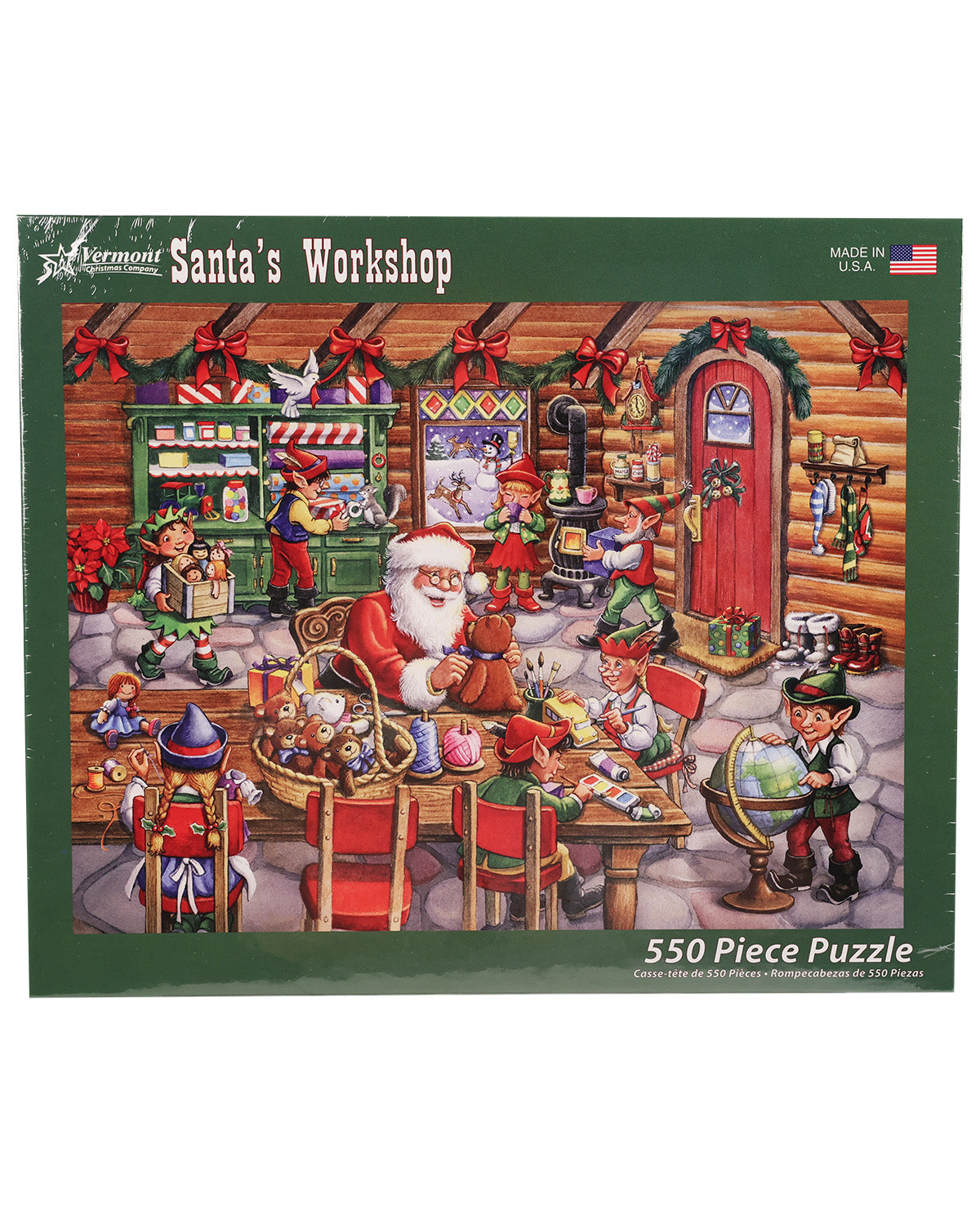 A 550-piece jigsaw puzzle box titled 'Santa's Workshop' by Asa Montour, featuring a colorful illustration of a cozy log cabin workshop filled with elves and Santa Claus.