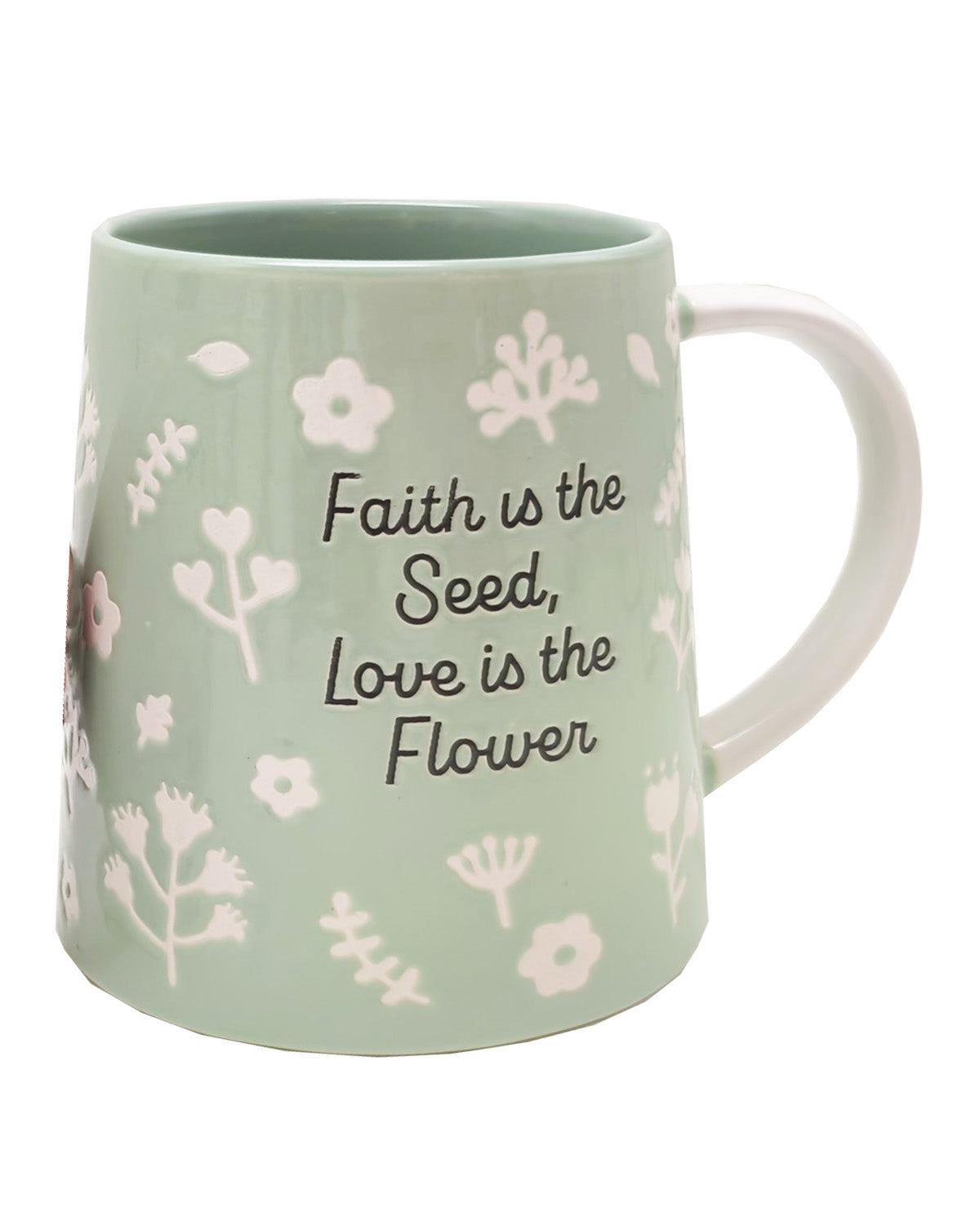 A mint green ceramic mug with a white handle, decorated with white botanical illustrations and the quote 'Faith is the Seed, Love is the Flower' in black text.