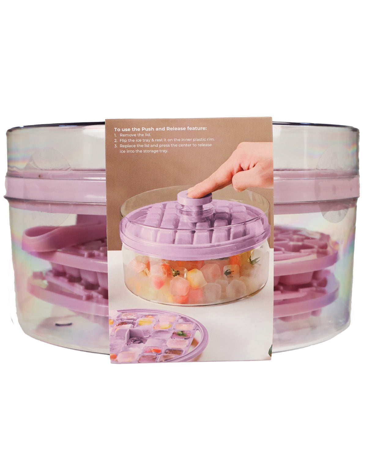 A clear plastic salad spinner with a lavender purple lid and matching inner spinner, shown with a paper instruction card in front. The card includes a photo of a hand pushing the central knob and a small inset showing the lid detached.