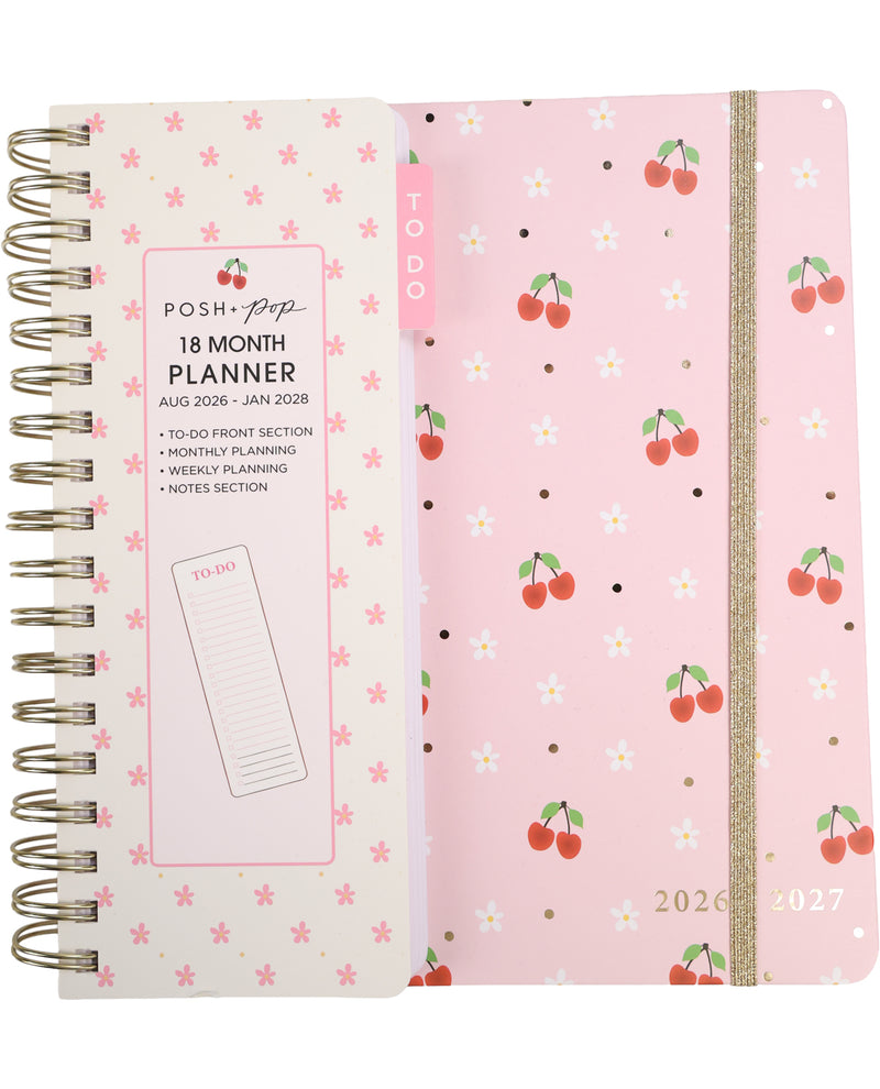 Two planners side by side, one with a floral pattern and the other with cherry design on a pink background.