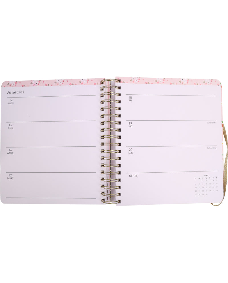 Open planner with pink floral design on a white background