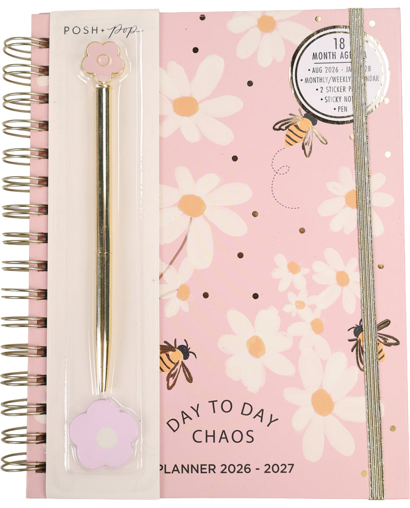 Planner with floral design and pen on pink background