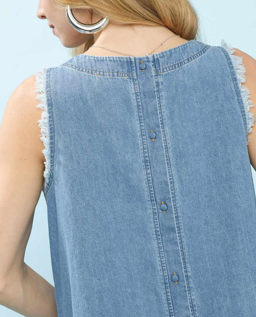Light blue denim sleeveless top with fringe details on a light blue background