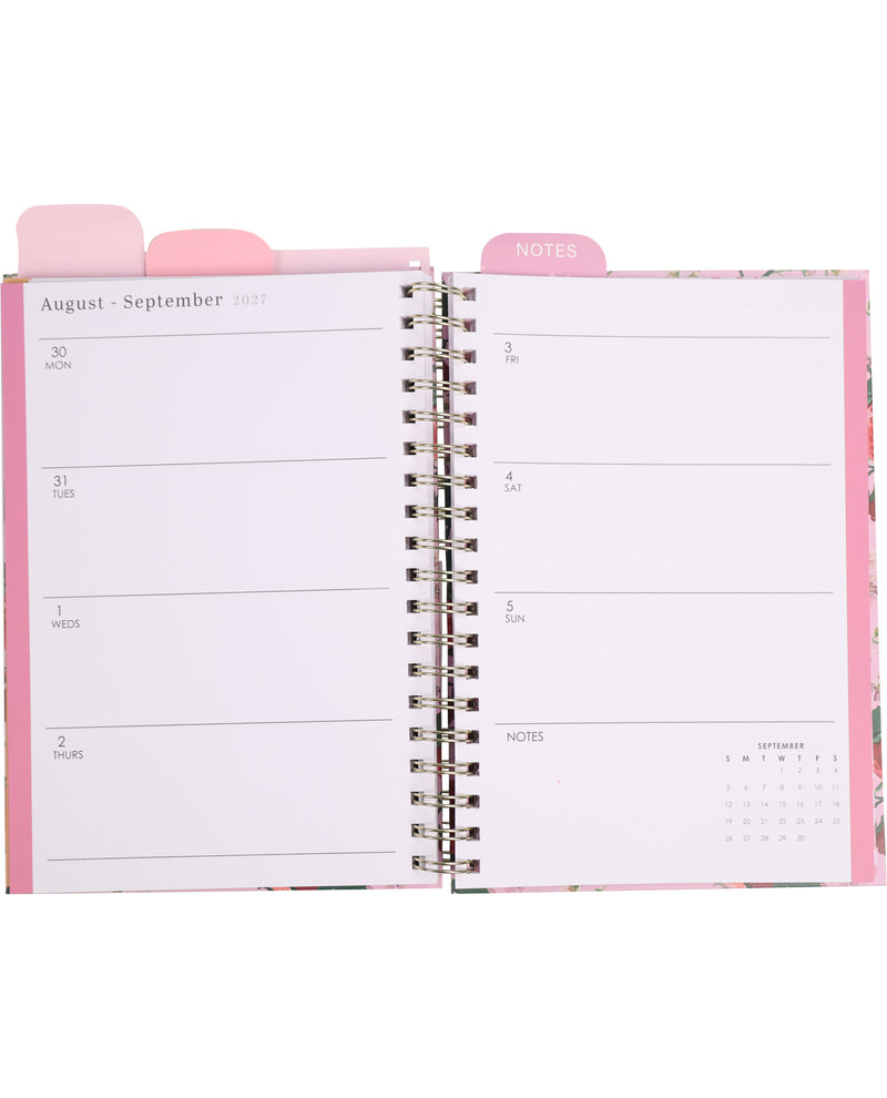 Open planner with pink cover and tab labeled 'Notes' on a white background