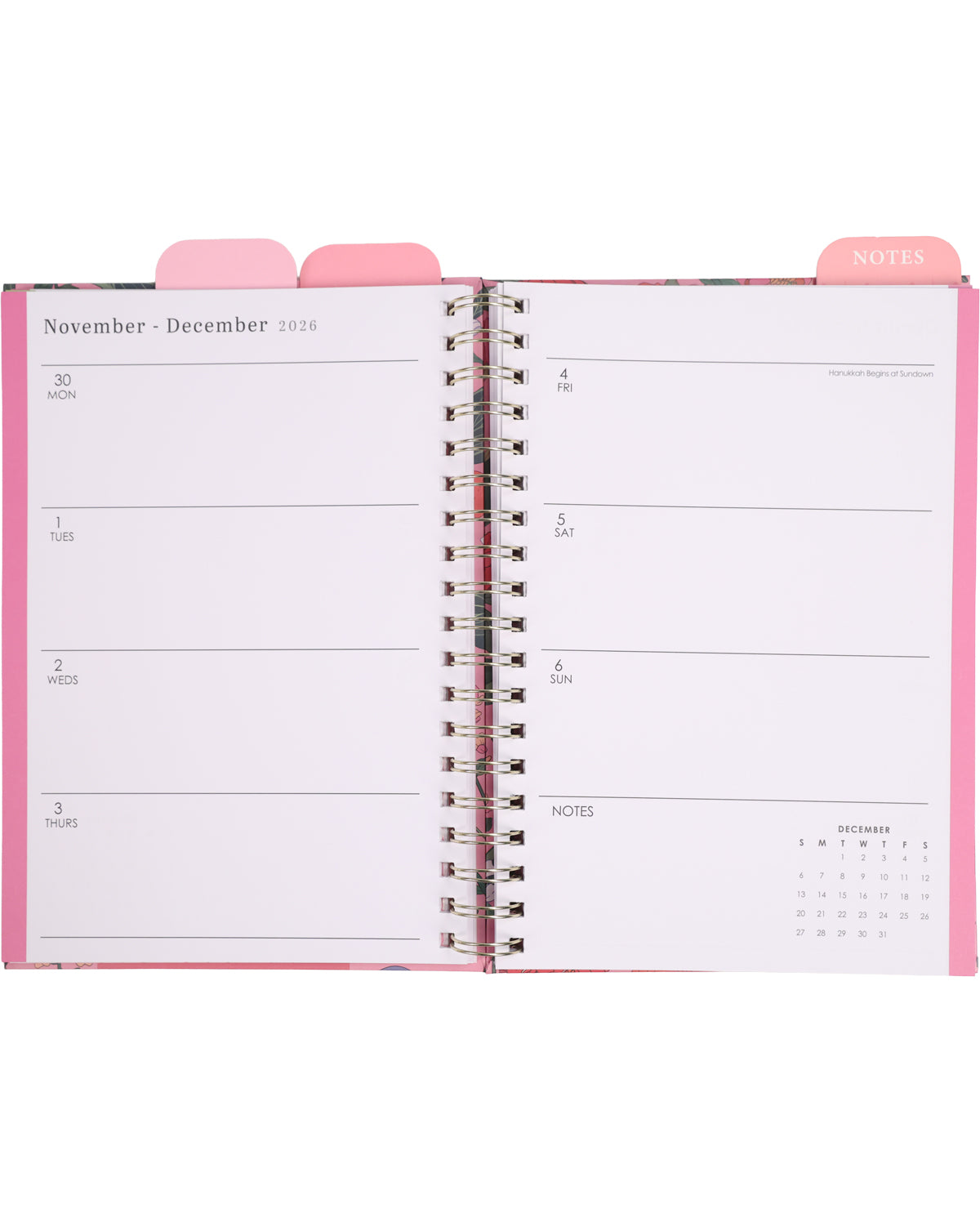 Open planner with pink cover and white pages displaying a monthly calendar.
