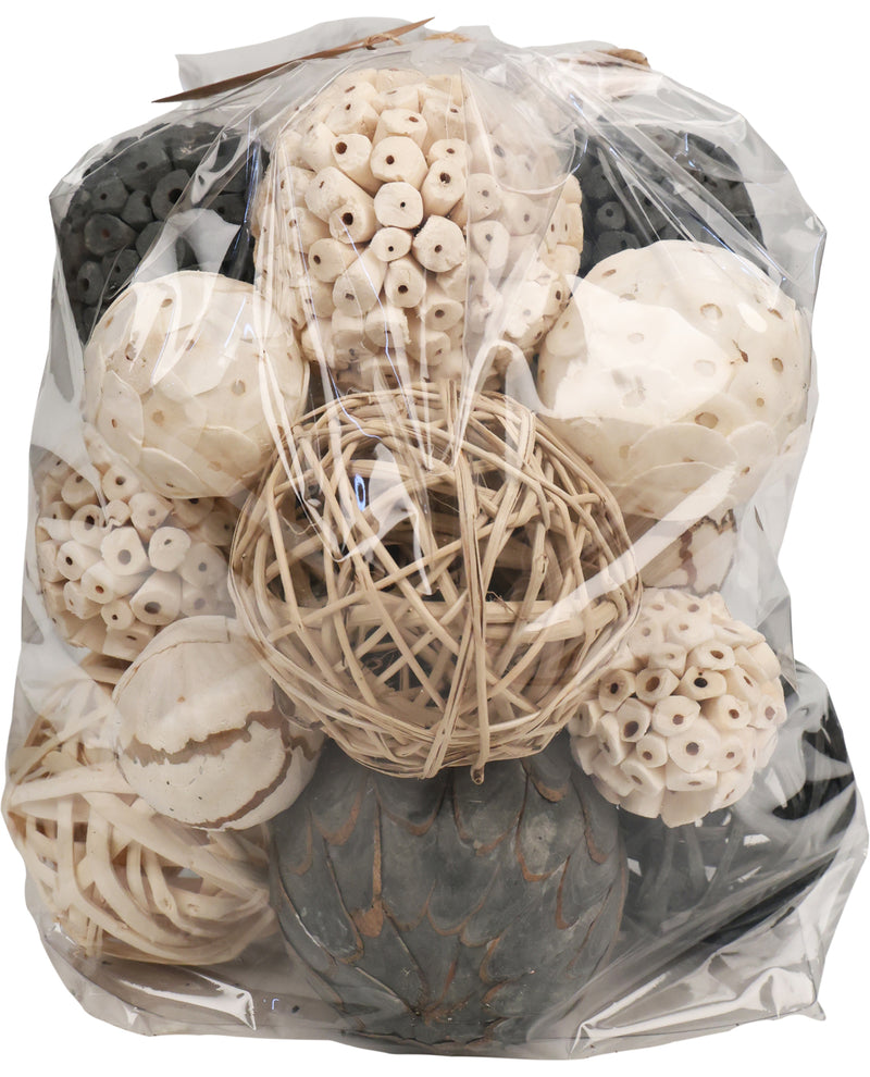 Bag of decorative items including shells and raffia in a clear package on a white background
