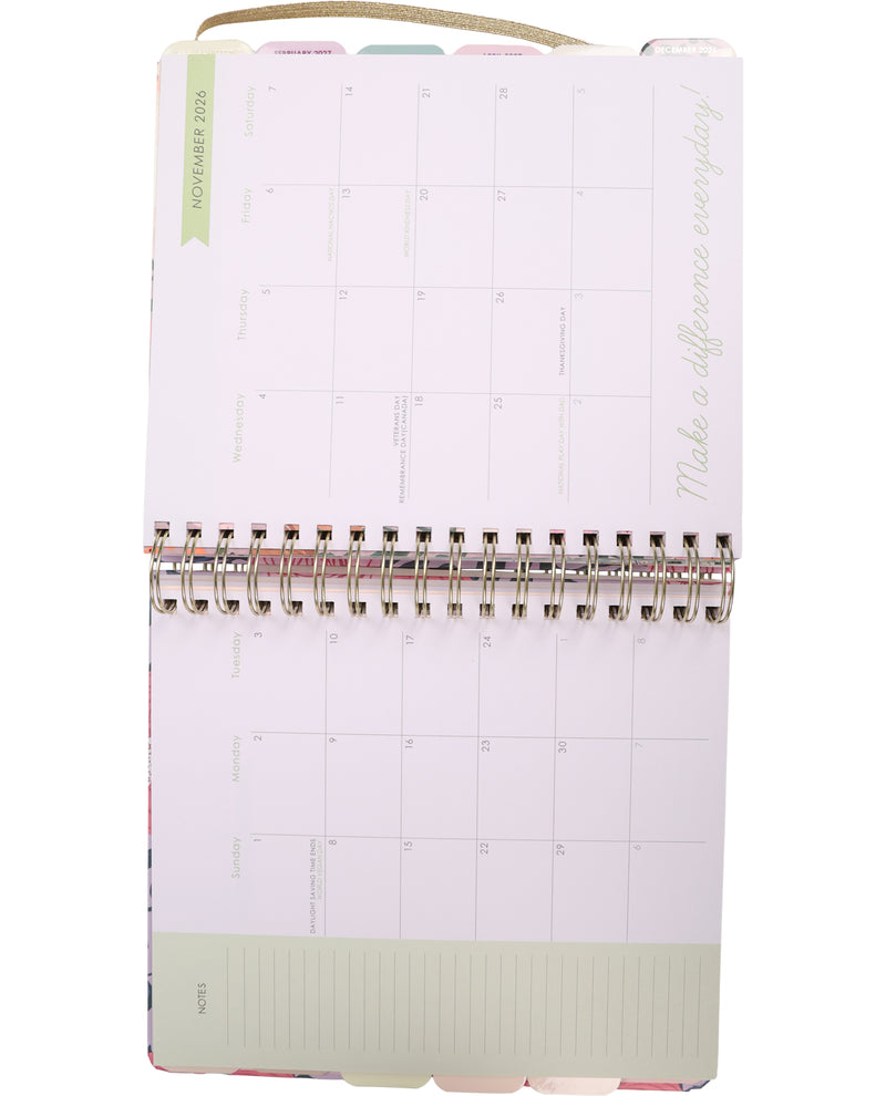 Planner with a white cover and pink spine on a white background