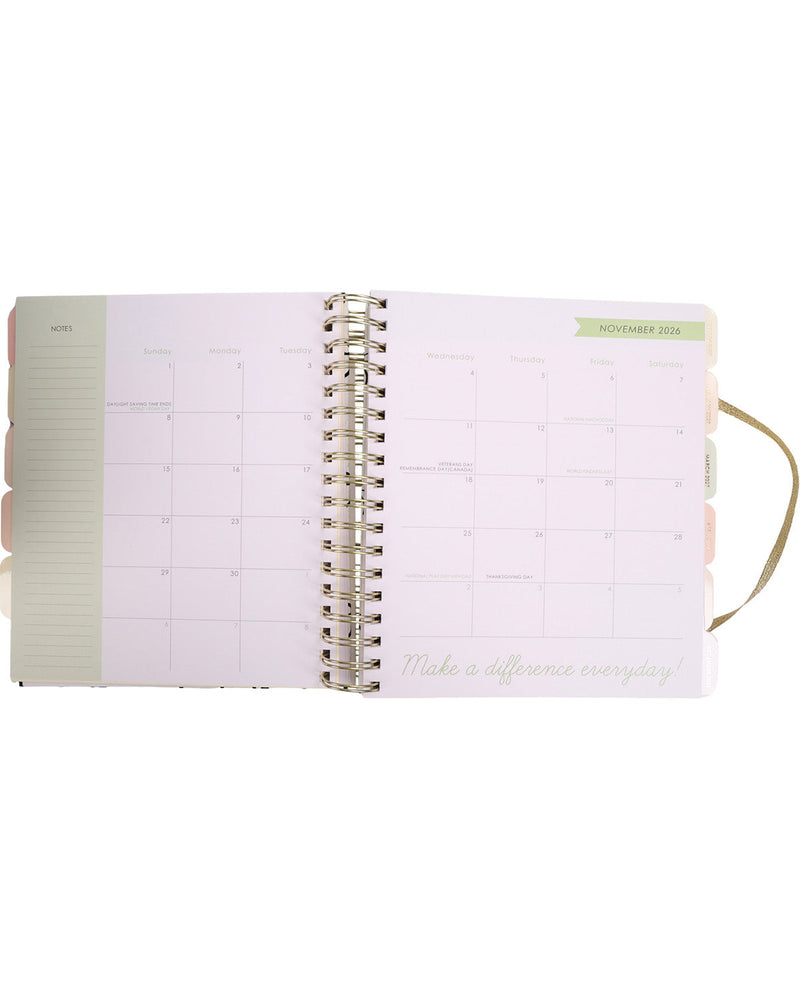 Open planner with spiral binding on a white background