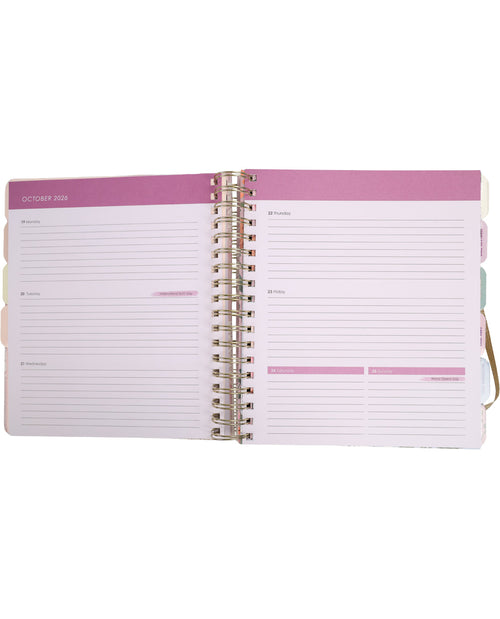 Open planner with pink cover and white pages on a white background