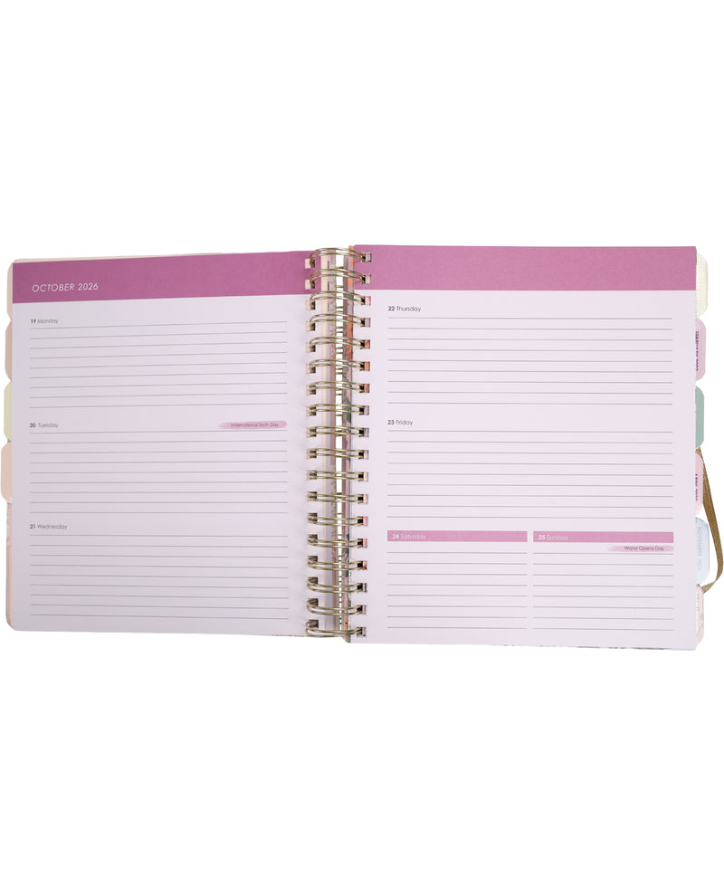 Open planner with pink cover and white pages on a white background