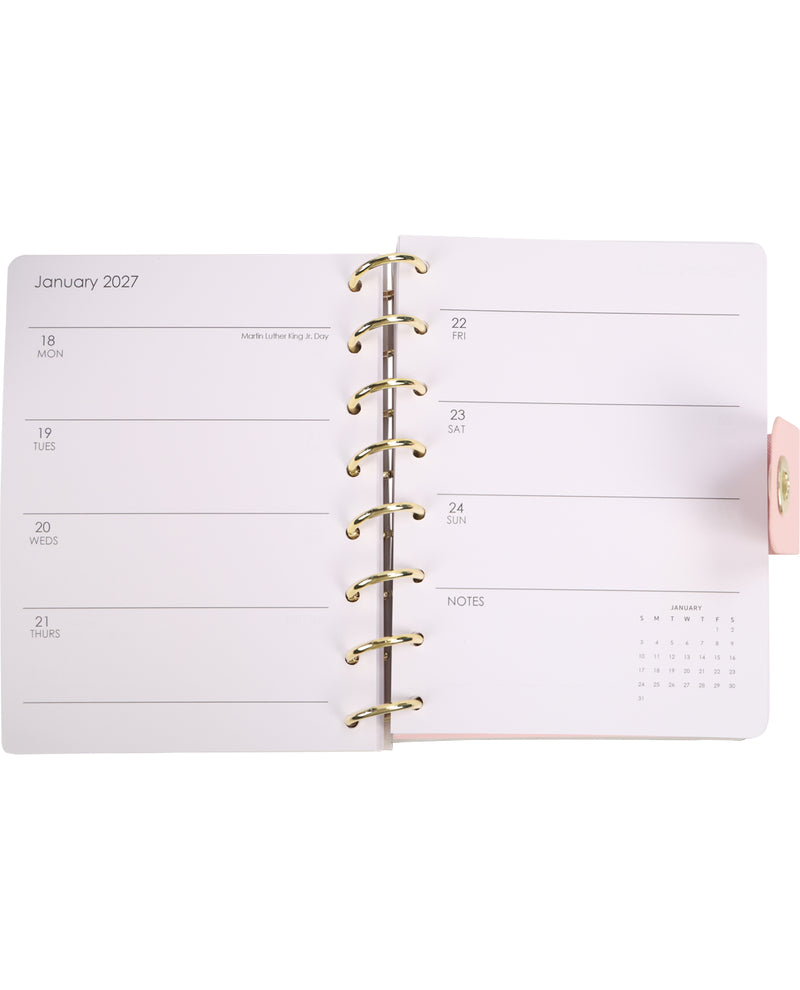 Open planner showing January 2023 with a pink cover on a white background