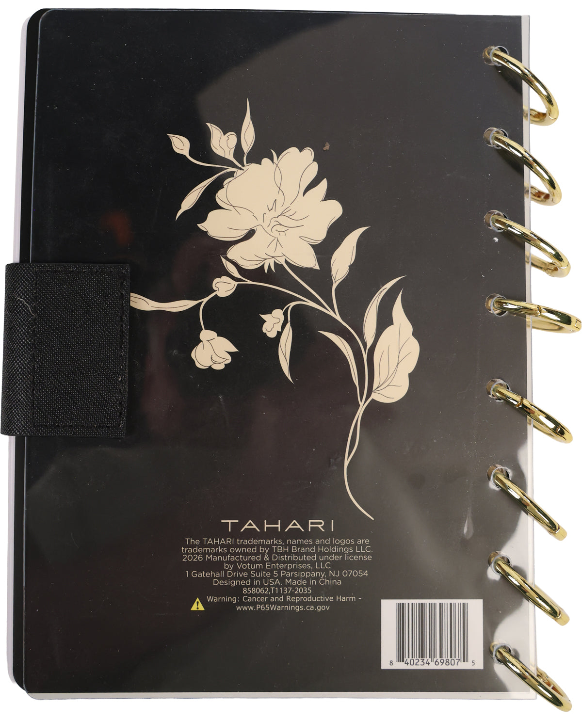 Black notebook with floral design and gold binding on a white background