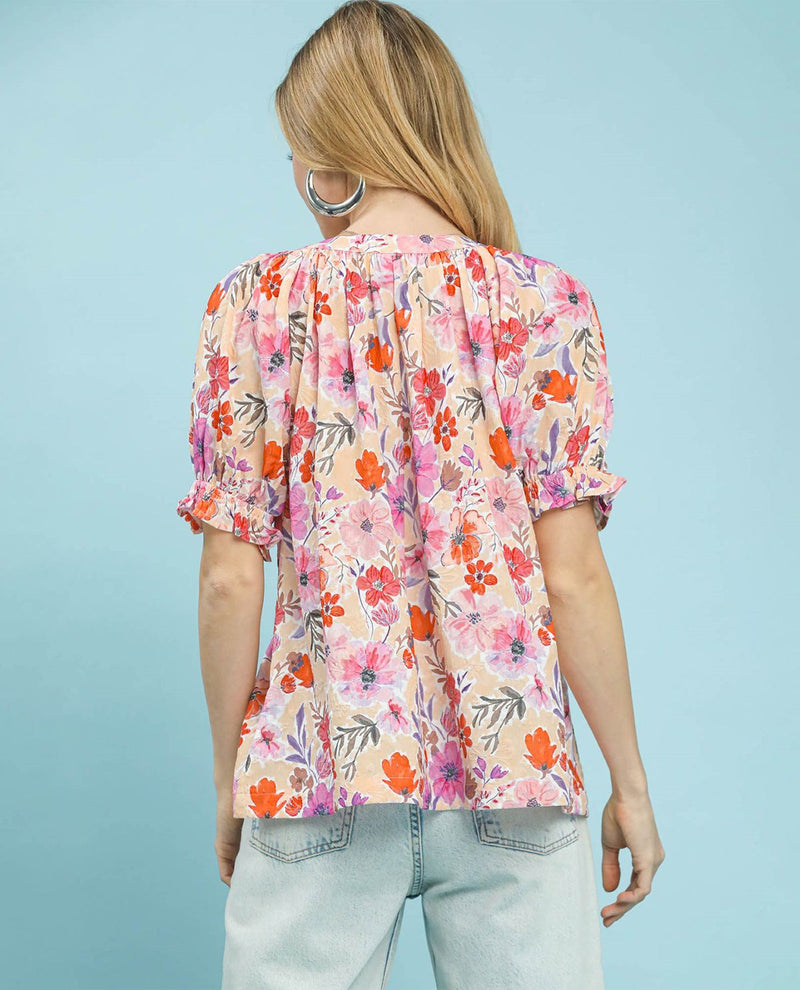 Woman wearing a floral blouse with a light blue background