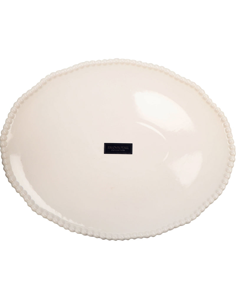 Round white plate with scalloped edge on a white background