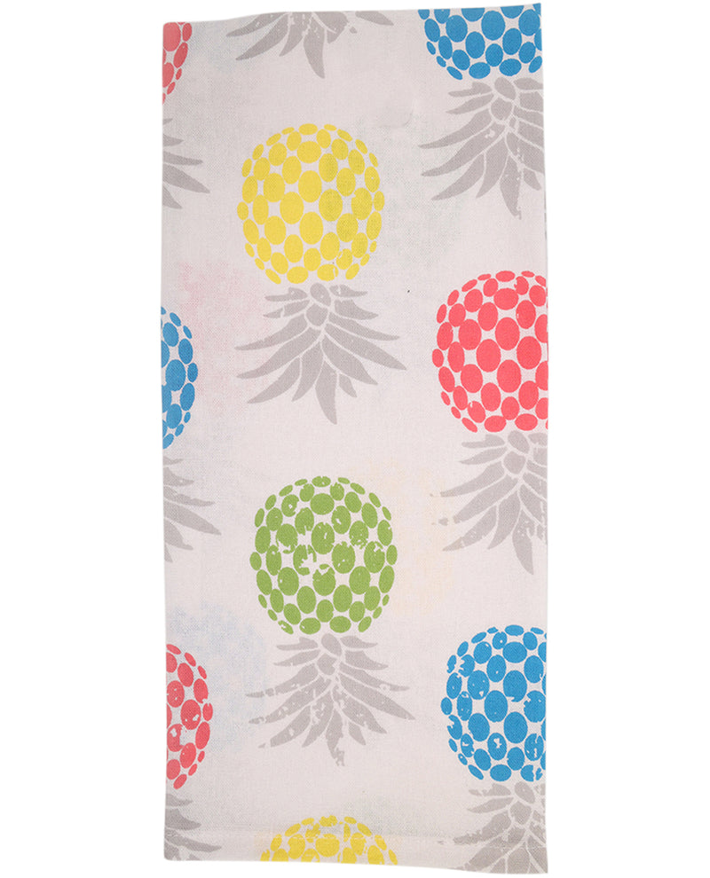 Folded towel with colorful pineapple pattern on a white background