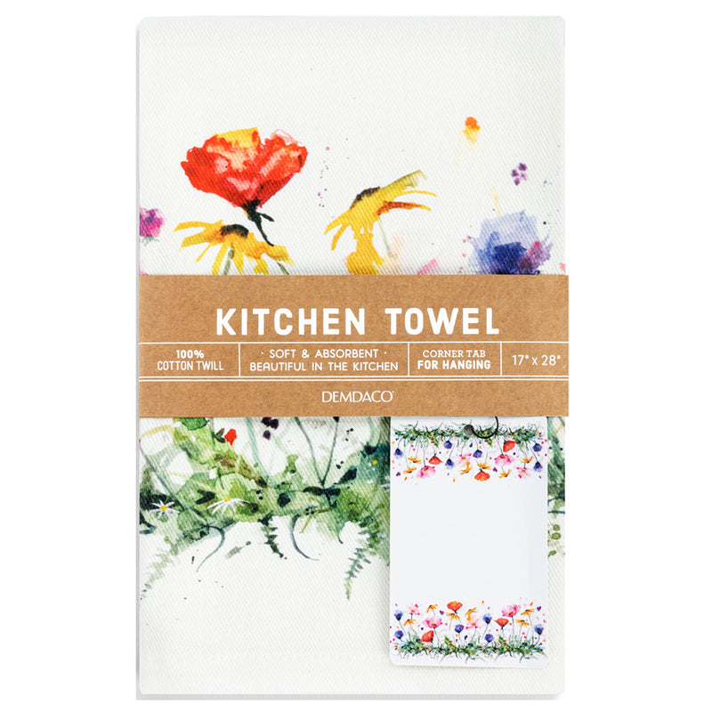 A Demdaco kitchen towel with a white background and colorful watercolor floral designs, wrapped in a brown paper band that reads 'KITCHEN TOWEL'.