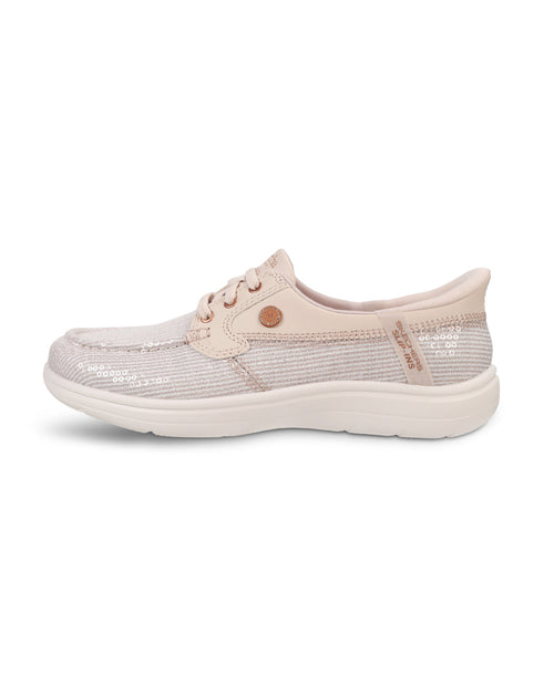 A single women's slip-on shoe in a light blush pink color, featuring a textured knit upper, matching pink laces, a small round metallic button, and a thick white sole, shown against a plain white background.