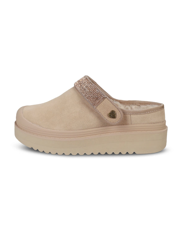 A single beige platform clog shoe with a textured strap embellished with rhinestones and a small metallic heart charm, shown against a plain white background.