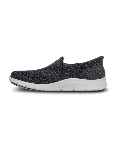 Black slip-on shoe with white sole on a white background