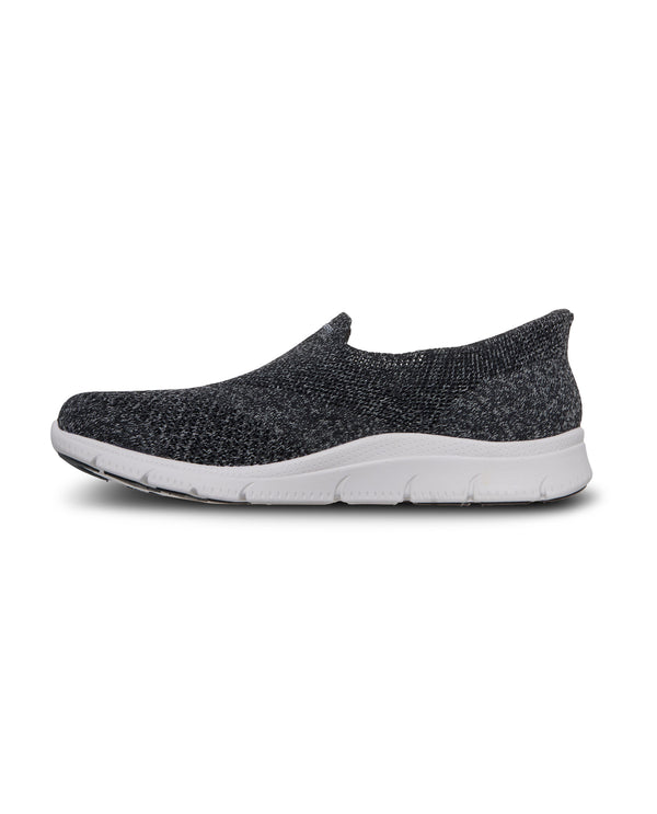 Black slip-on shoe with white sole on a white background